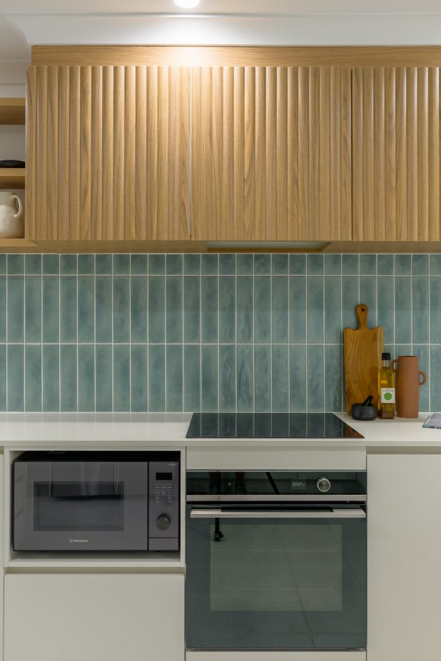 Kitchen with minty green subway tiles